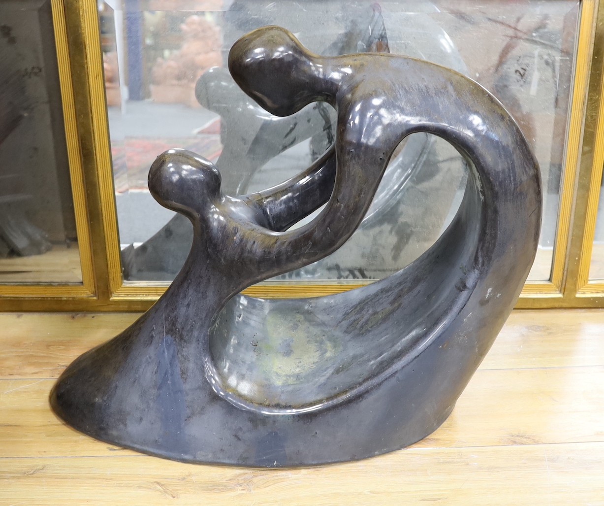 A silver lustred terracotta sculpture in the style of B. Hepworth, 59cms high